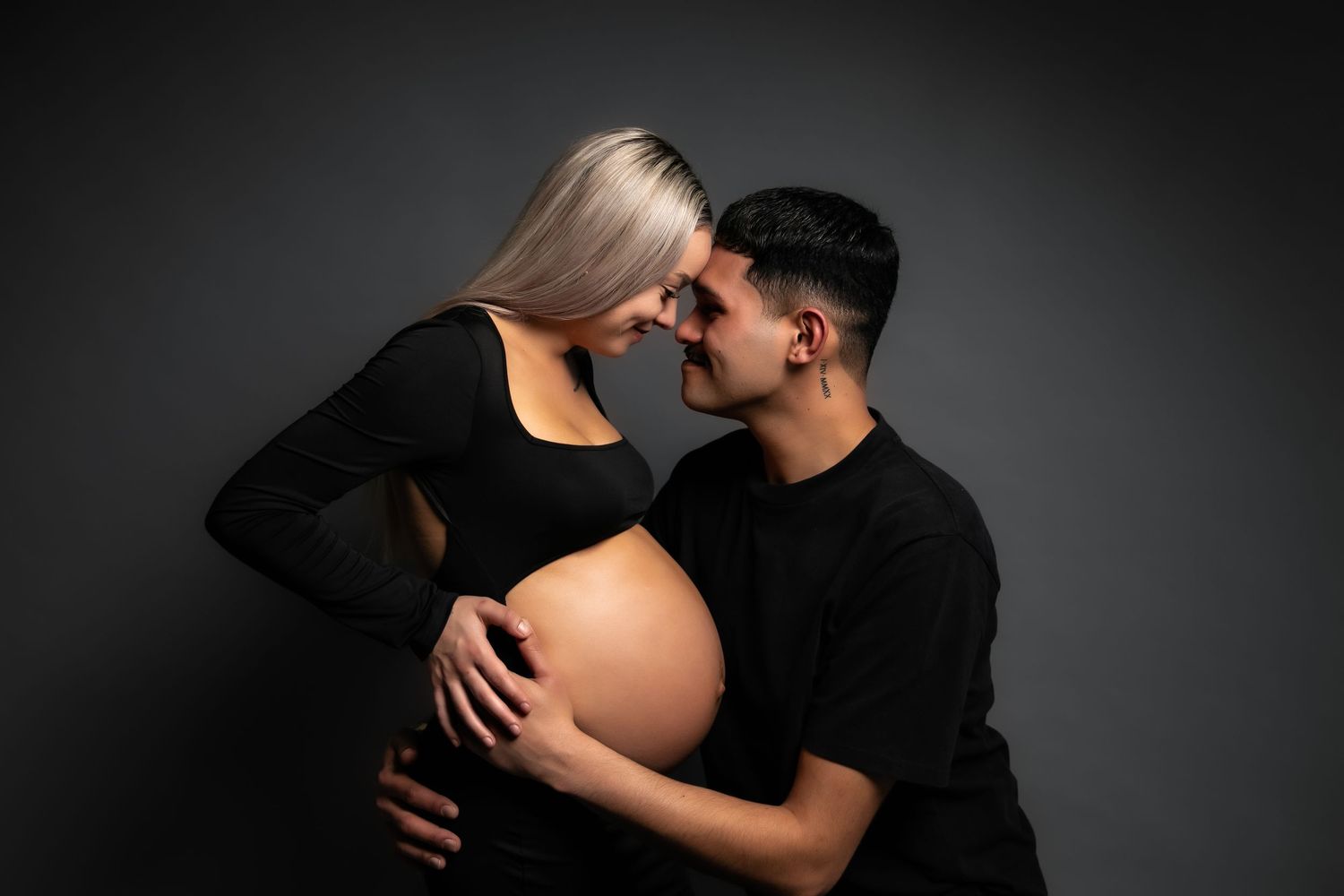 A series of romantic silhouette photos showing a couple embracing against a dark background.