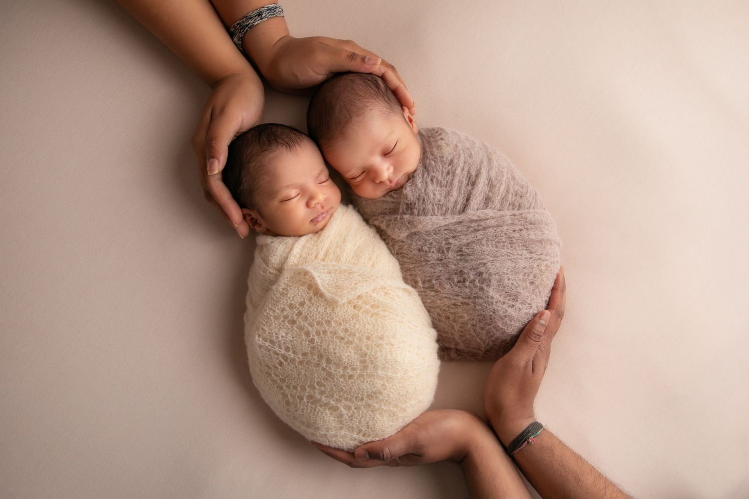 A series of seven newborn photography portraits showing a sleeping baby in various poses on soft beige backdrops.