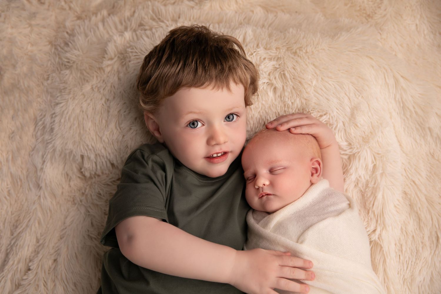 A heartwarming series of photos showing a young child gently embracing and bonding with a newborn baby.