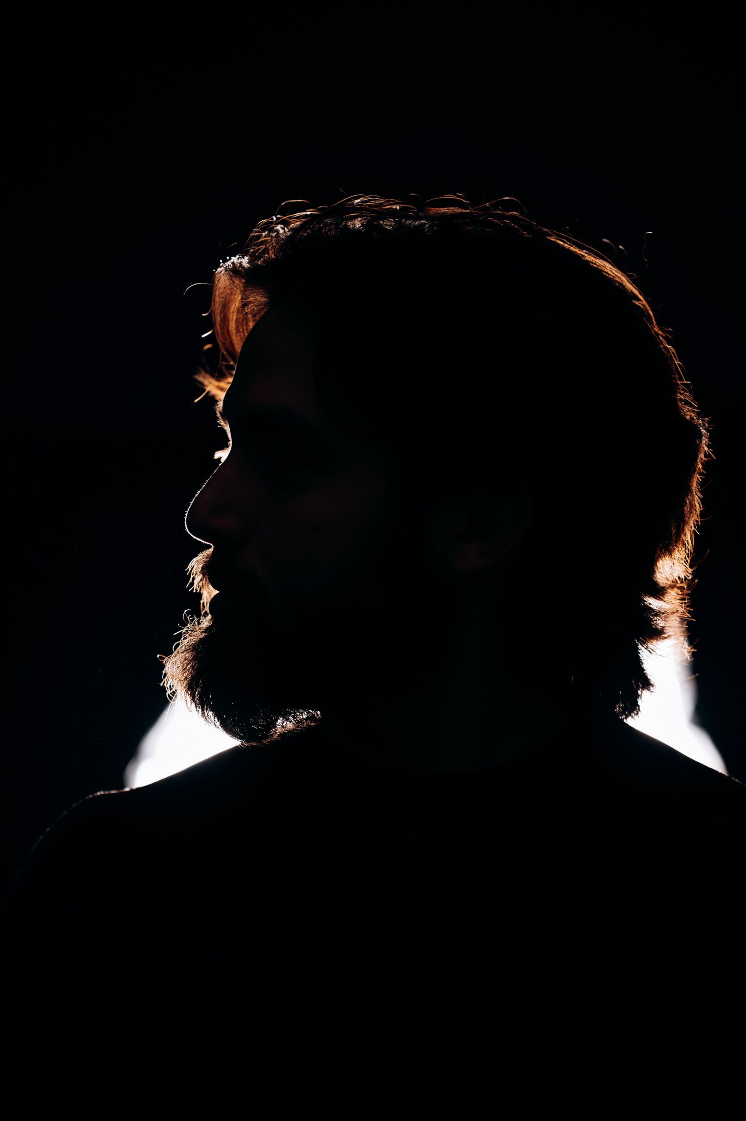 Dramatic backlit silhouette profile shots creating mysterious atmosphere.