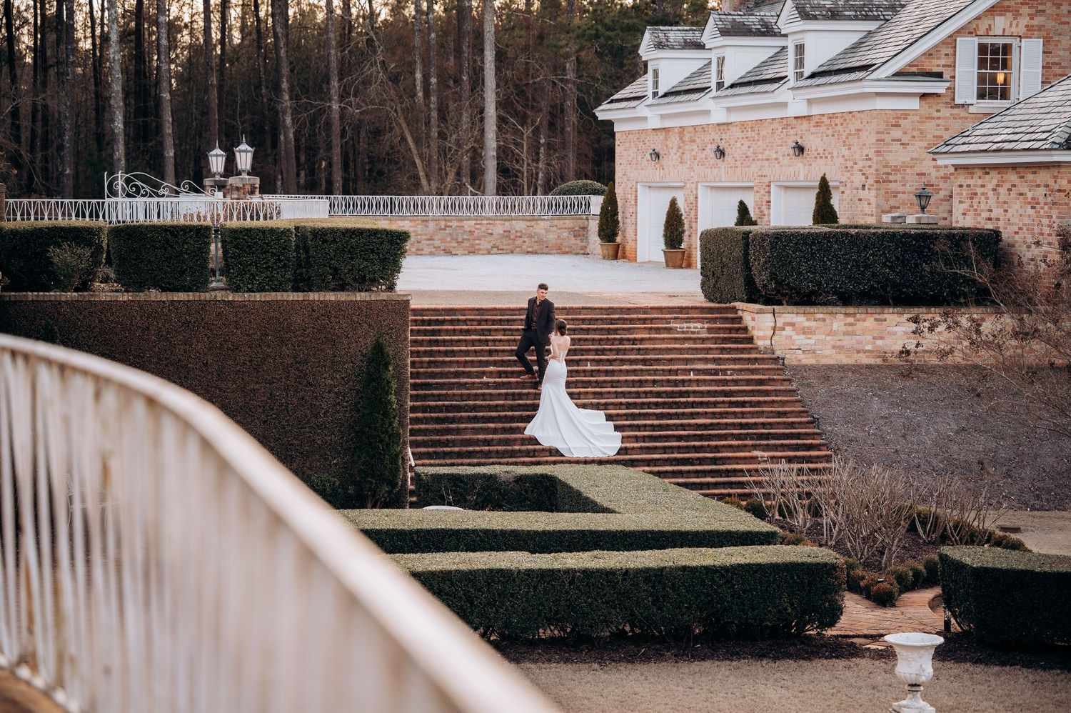 An elegant brick staircase with landscaped gardens creates a romantic outdoor setting.