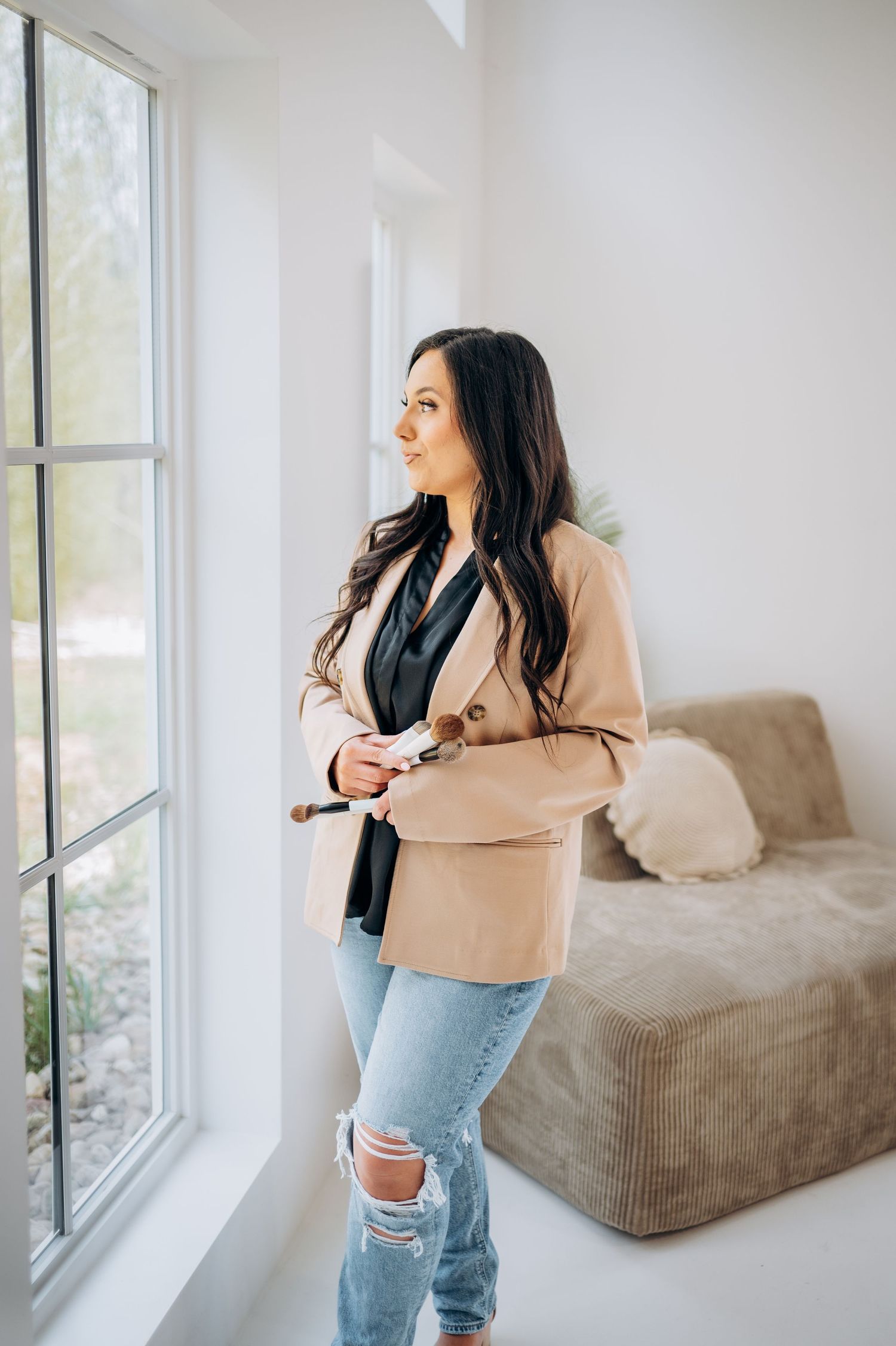 Stylish casual business outfit photographed in bright modern room with large window.
