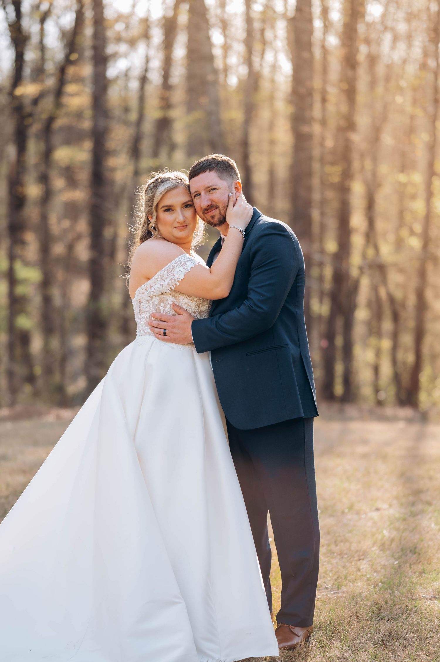Romantic wedding portraits captured in a sunlit autumn forest.