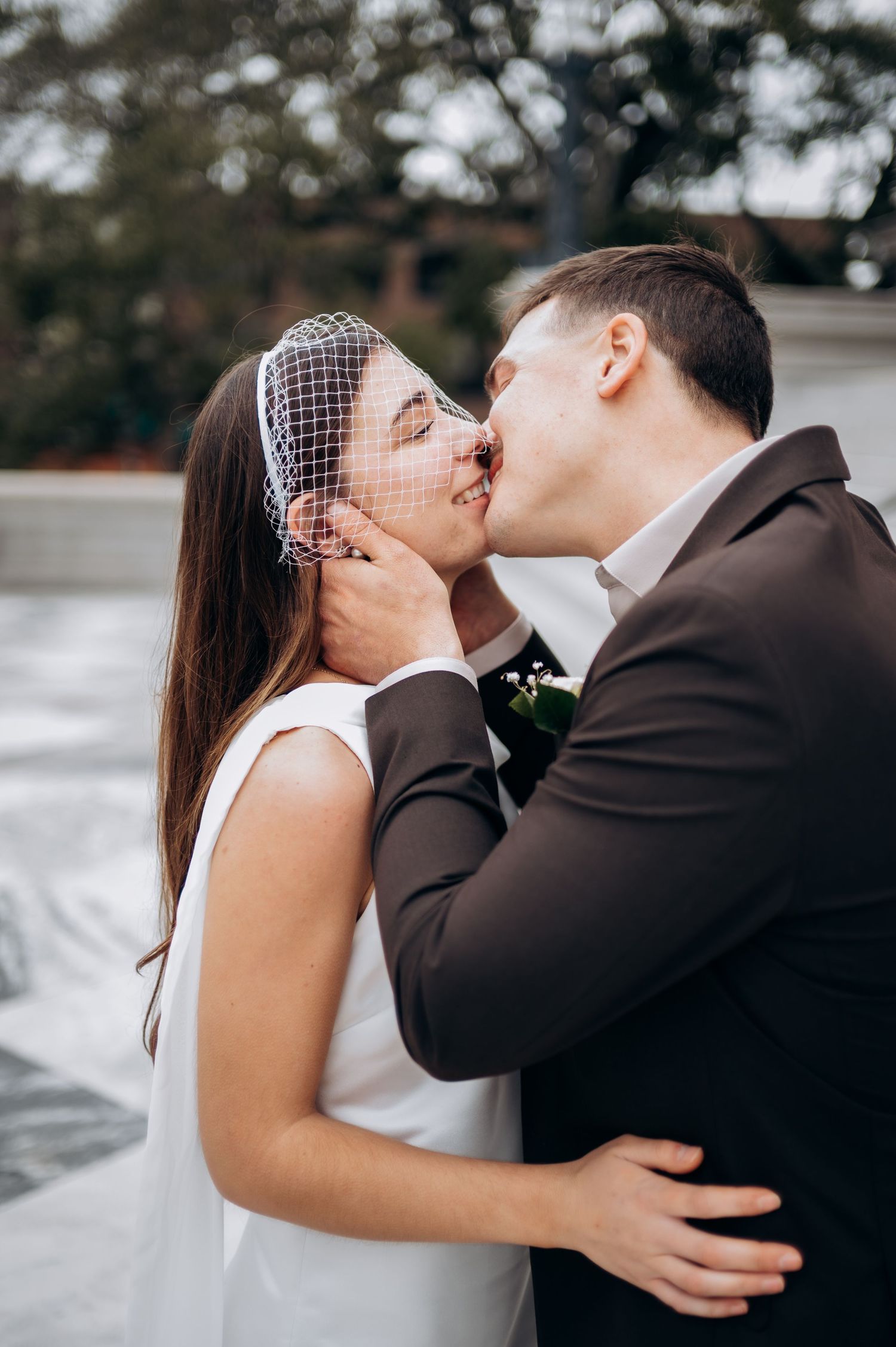 A romantic wedding photo sequence showing a couple sharing a tender kiss in a white dress and dark suit.