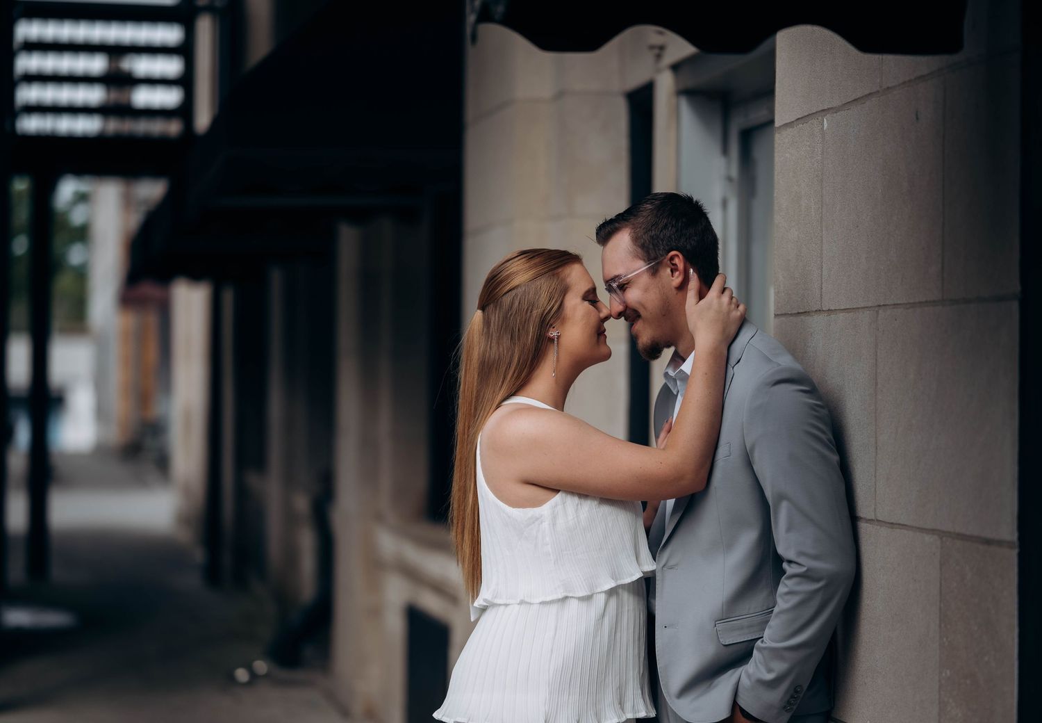 An intimate couple's portrait captured under an architectural overhang.