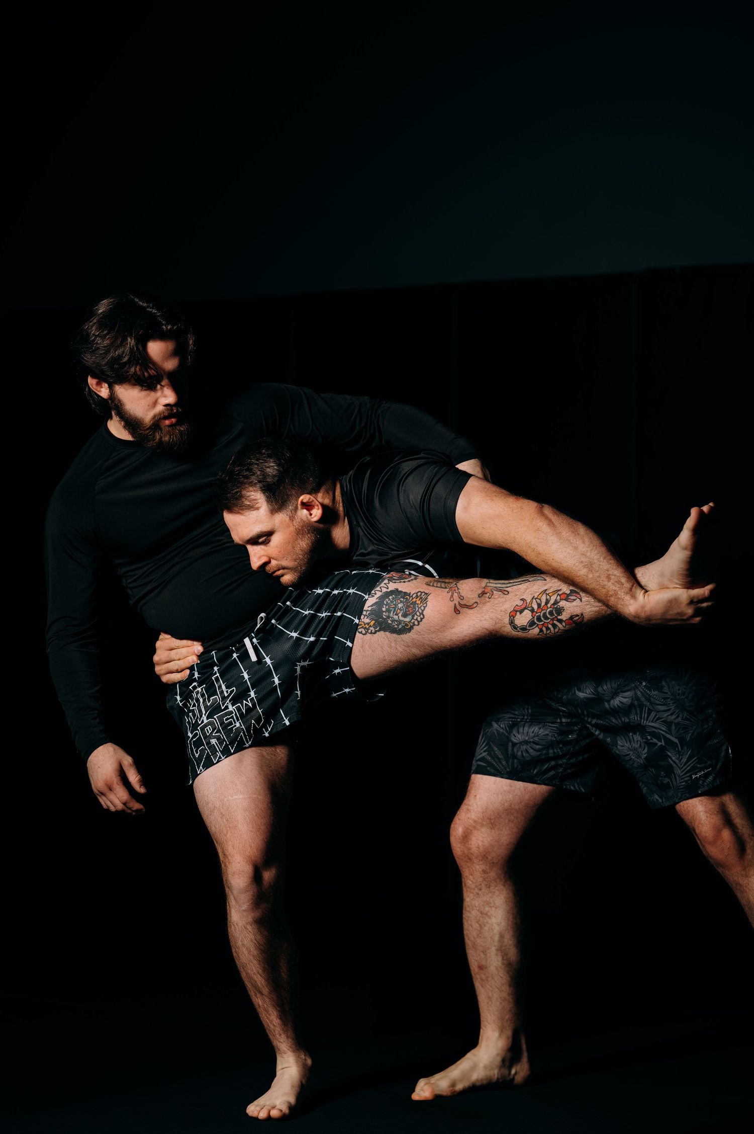 Athletic figure demonstrates dynamic martial arts kick pose against dark background.