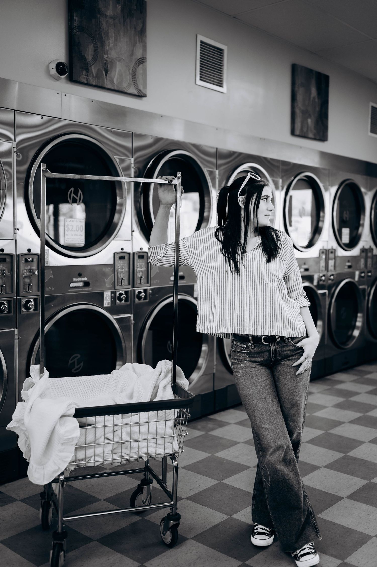 Black and white photos show people doing laundry in a laundromat with washing machines and carts.