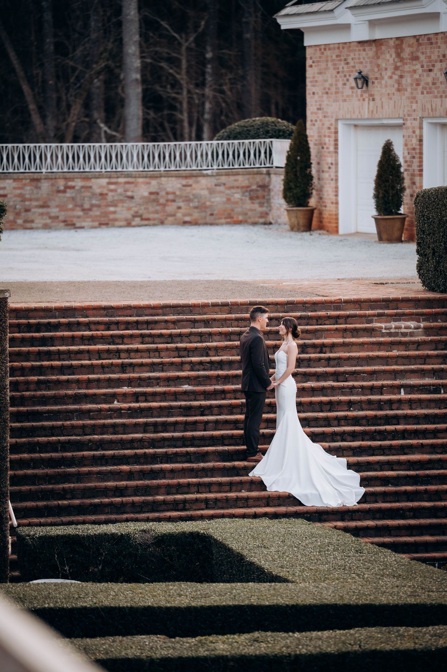 Wedding photography sequence on grand brick steps leading to a stately white columned building.