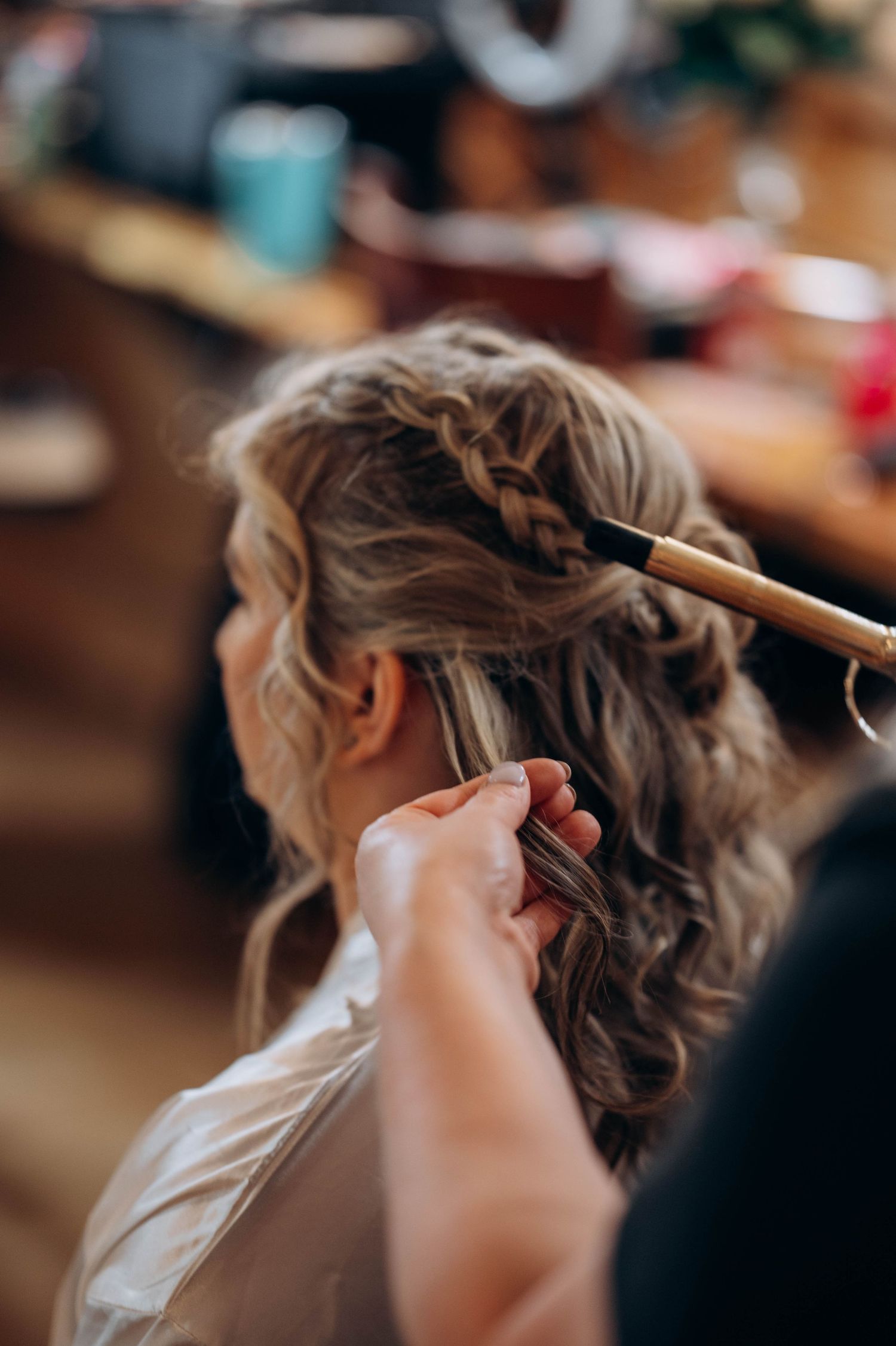 Close-up of elegant bridal hairstyling in progress.