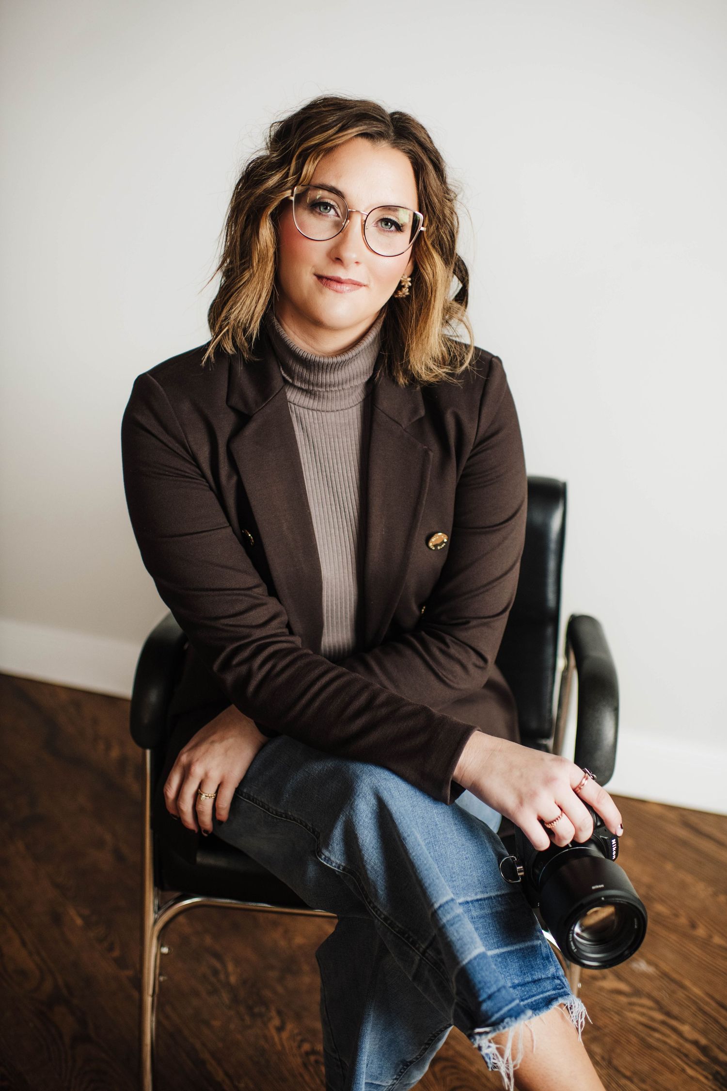 Professional lifestyle photography of someone in business casual attire seated in studio setting.