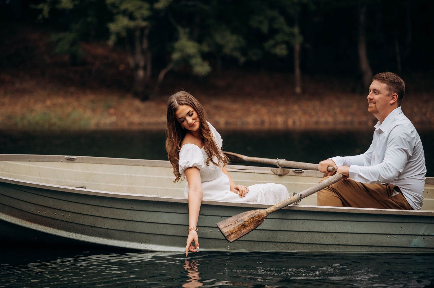 A series of romantic photos showing a couple getting close in a wooden boat on a lake.