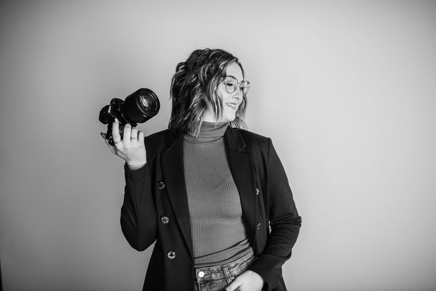 Series of dynamic poses with camera equipment against white backdrop.