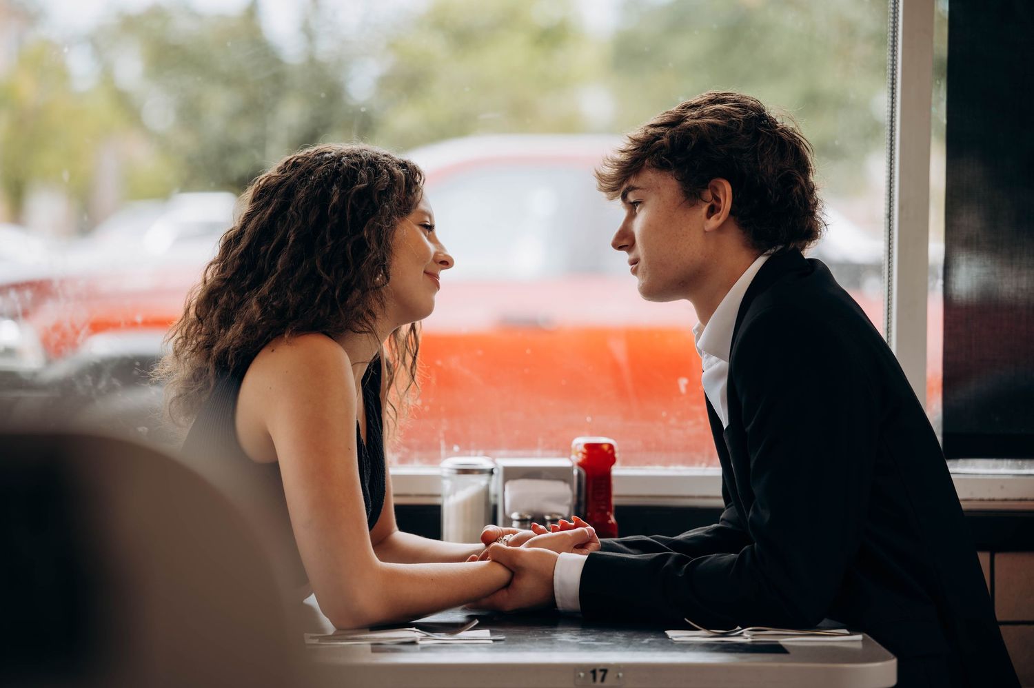 Couple gazing at each other across a Waffle House dining table.