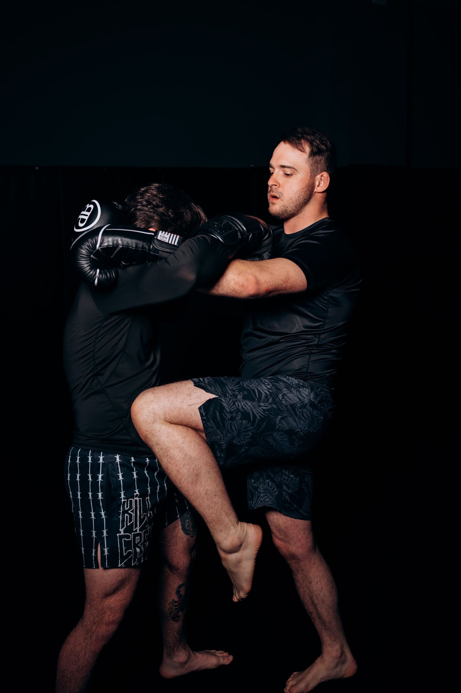 Martial arts training sequence showing kickboxing moves in dark setting.