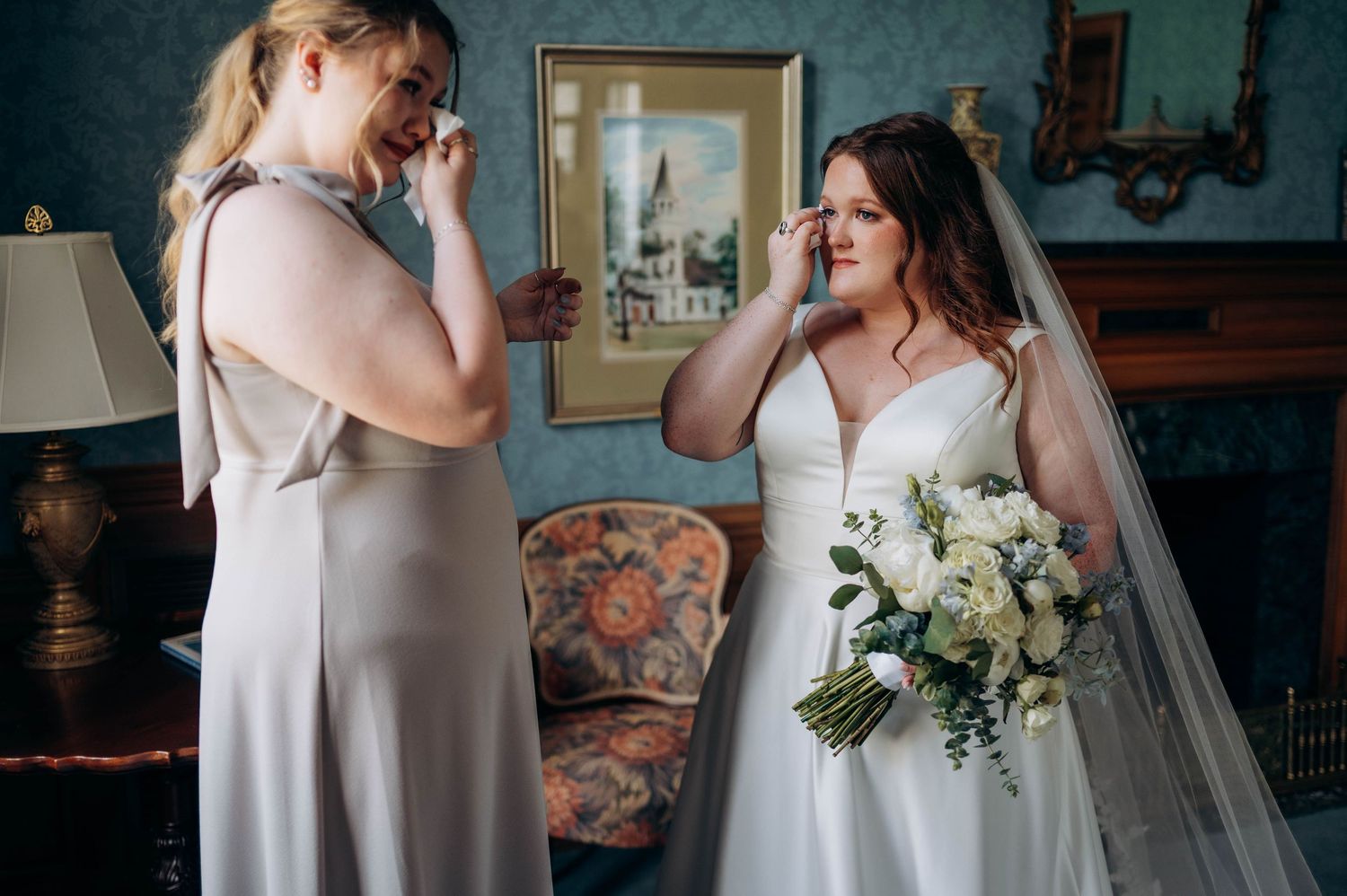 An emotional moment shared during wedding preparations in an elegant room.