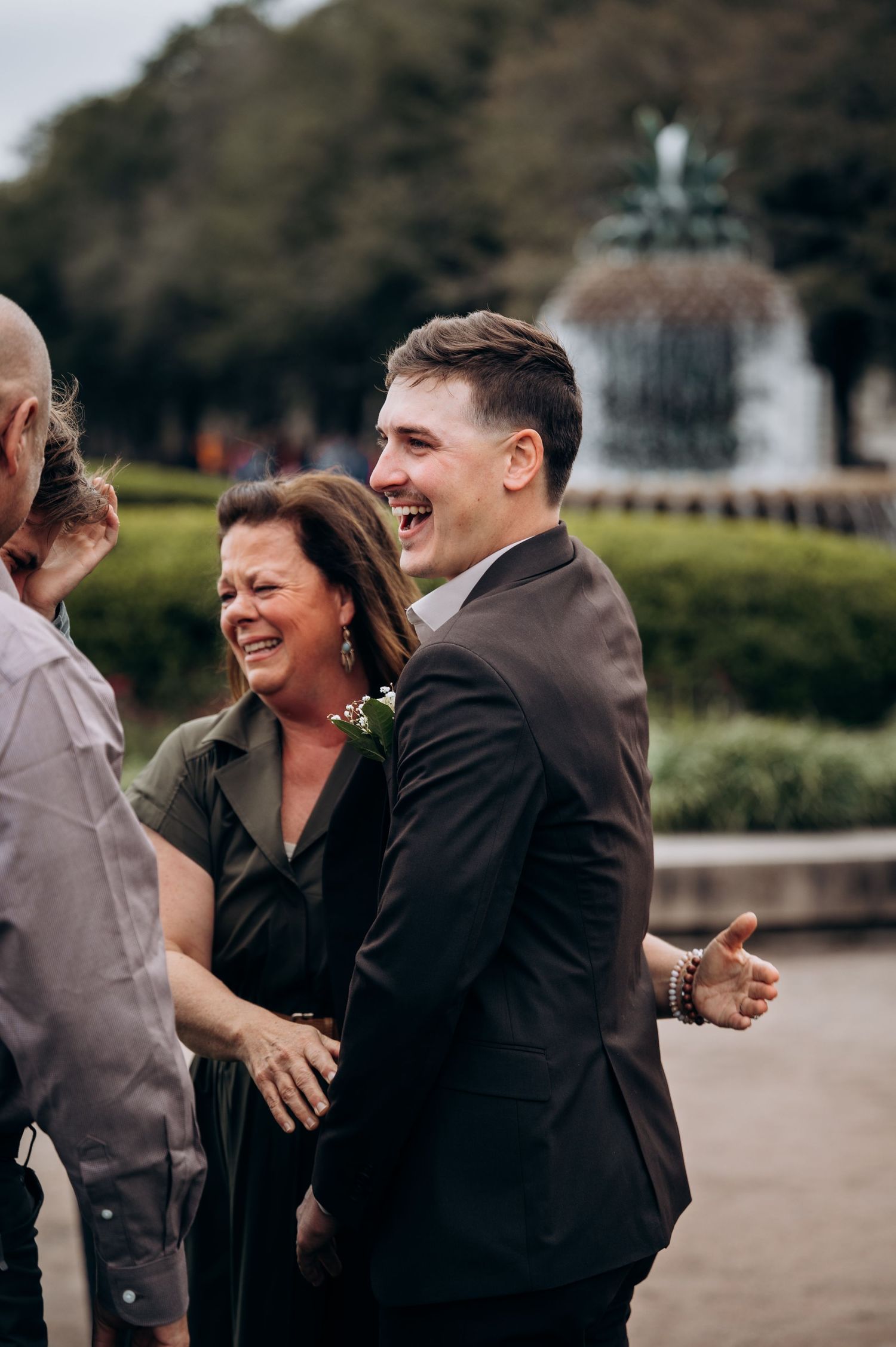A joyful moment shared between family members at an outdoor wedding celebration.