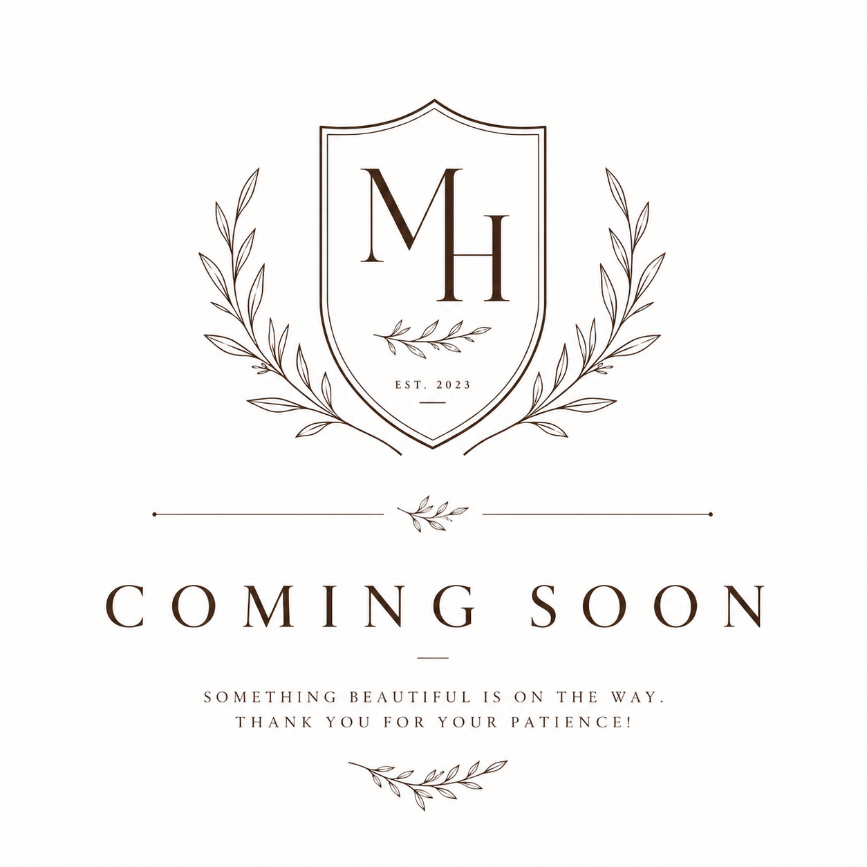 Elegant MH monogram crest logo with laurel branches and EST. 2023, above a Coming Soon announcement message.