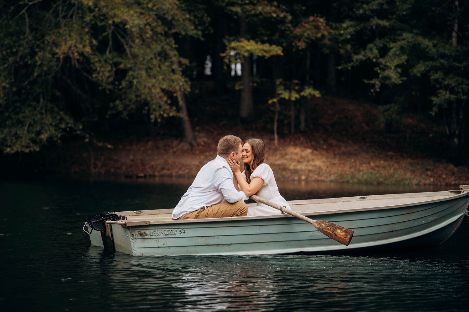 Romantic boat photoshoot sequence showing tender moments on a serene lake.