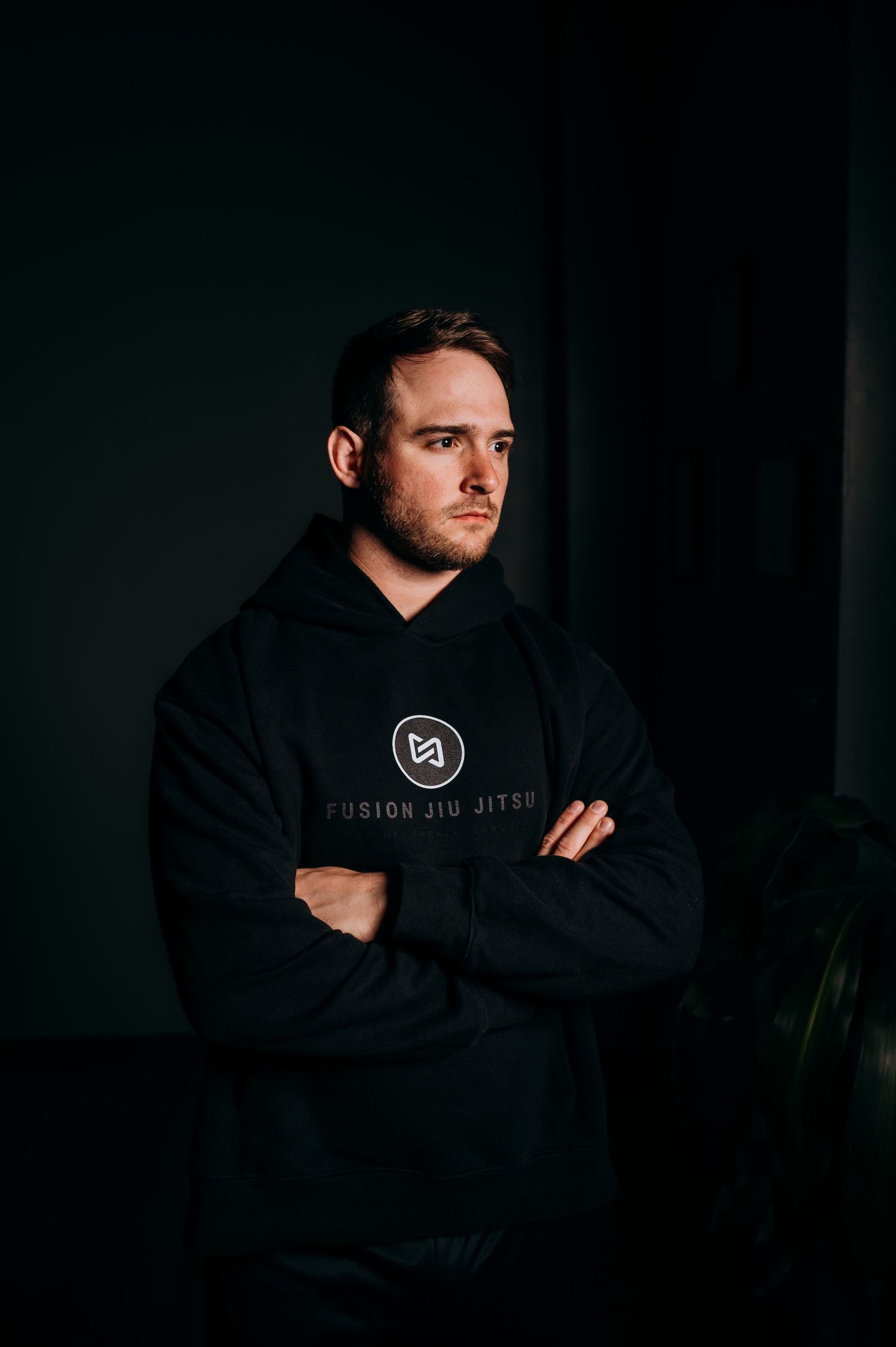 Moody portrait series showing a person in a black hoodie against dark background.