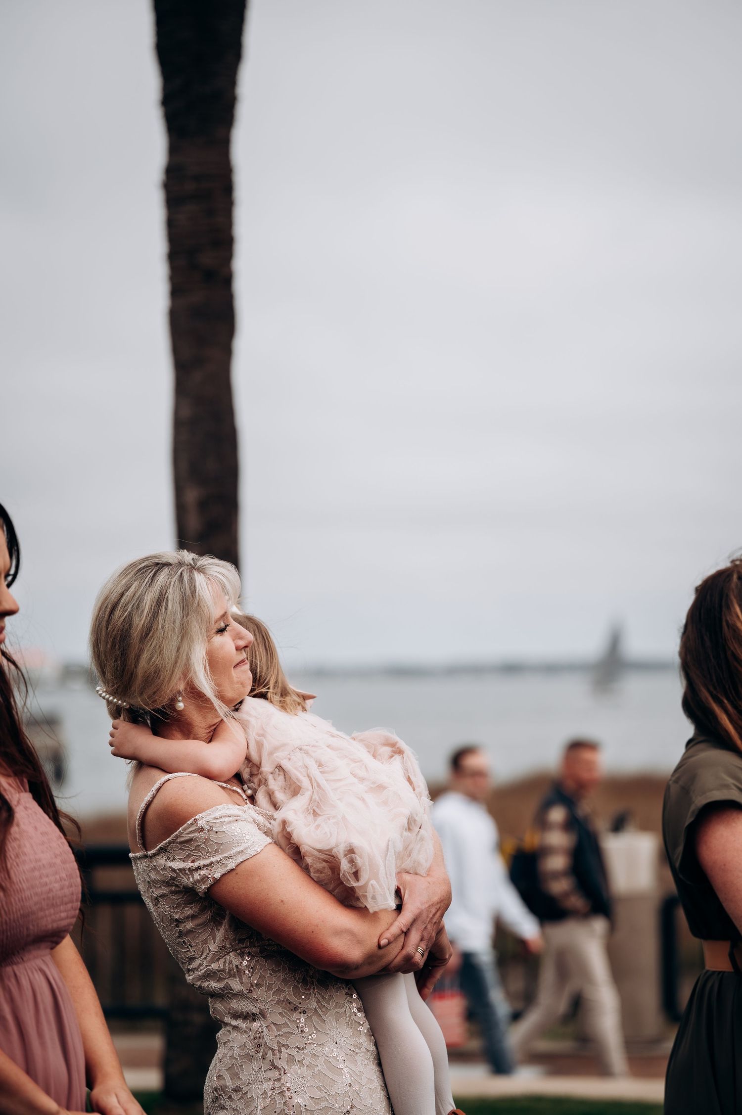 Emotional embrace captured during outdoor celebration.