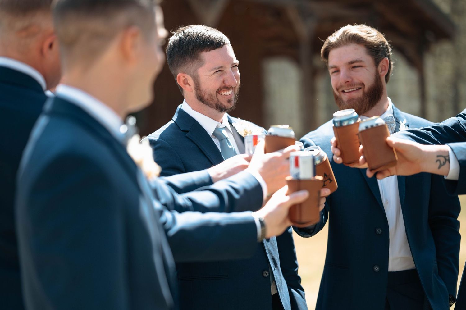 Groomsmen share laughs and gestures during pre-wedding celebrations.