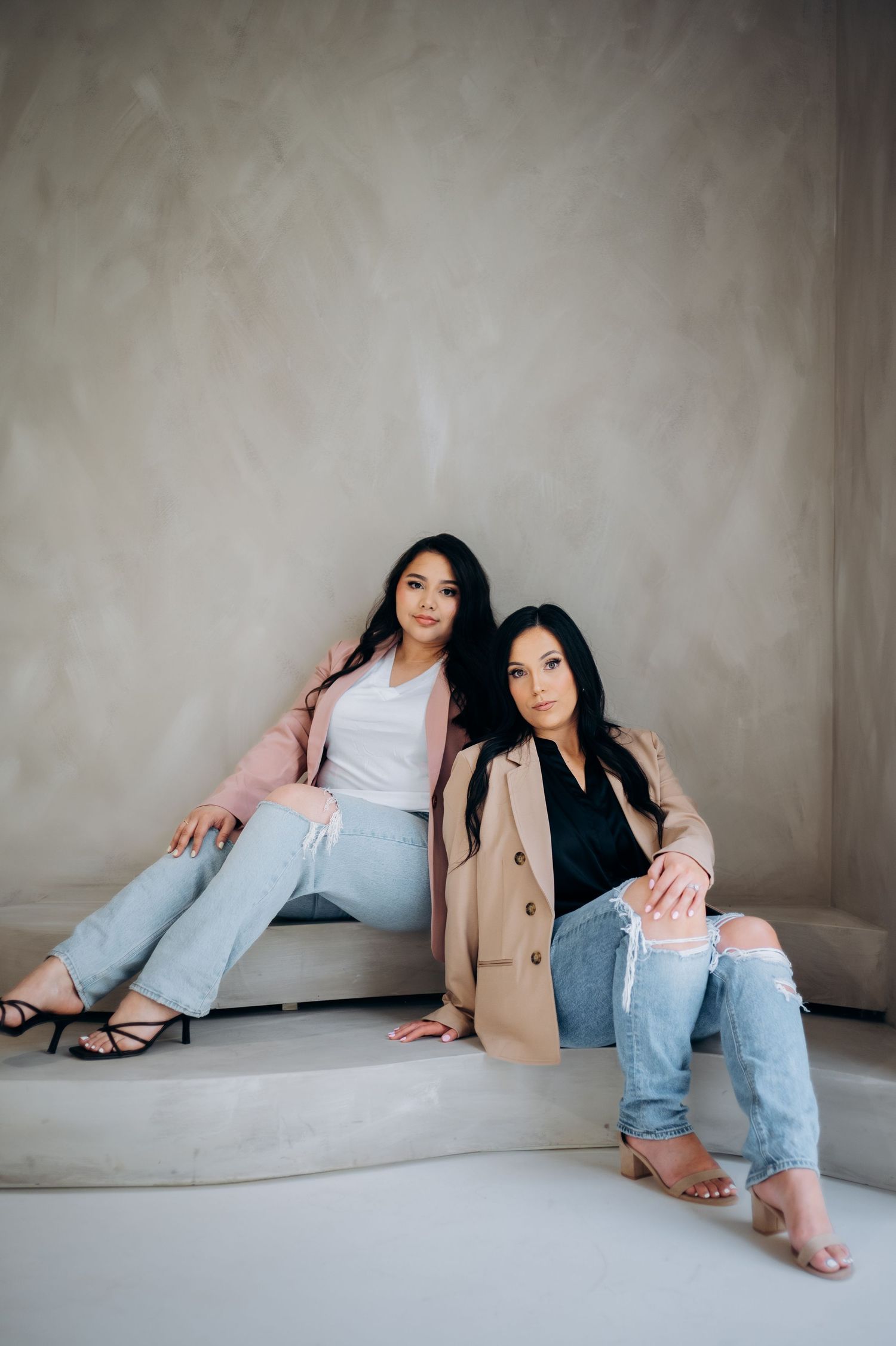 Artistic fashion portraits showing model in casual attire lounging against concrete wall in various poses.