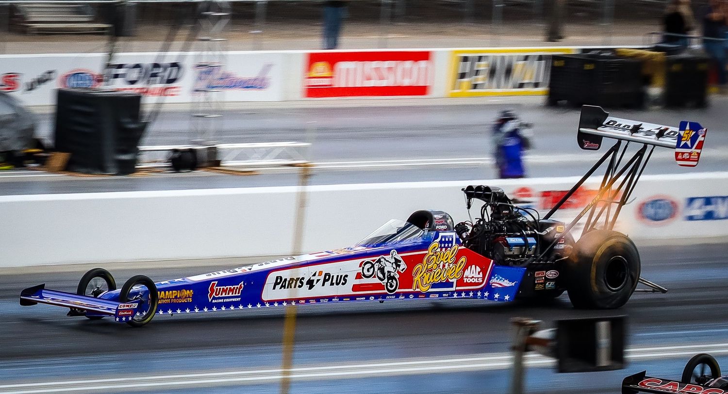 Drag racing action sequence showing multiple cars racing down the track.