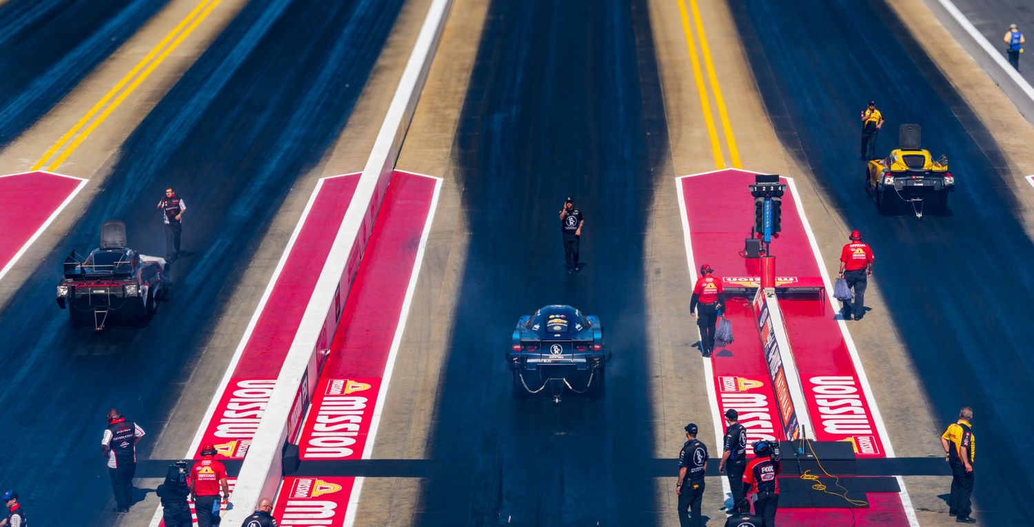 Colorful racing lanes with yellow and pink stripes viewed from above during competition.