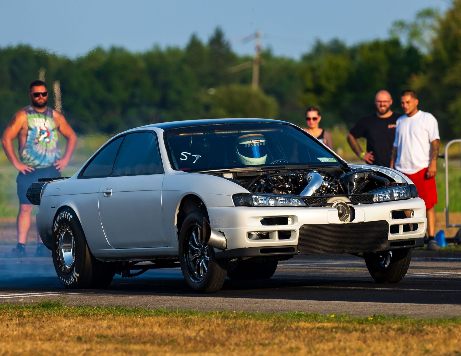 Classic and modern sports cars showcased at an outdoor automotive gathering.