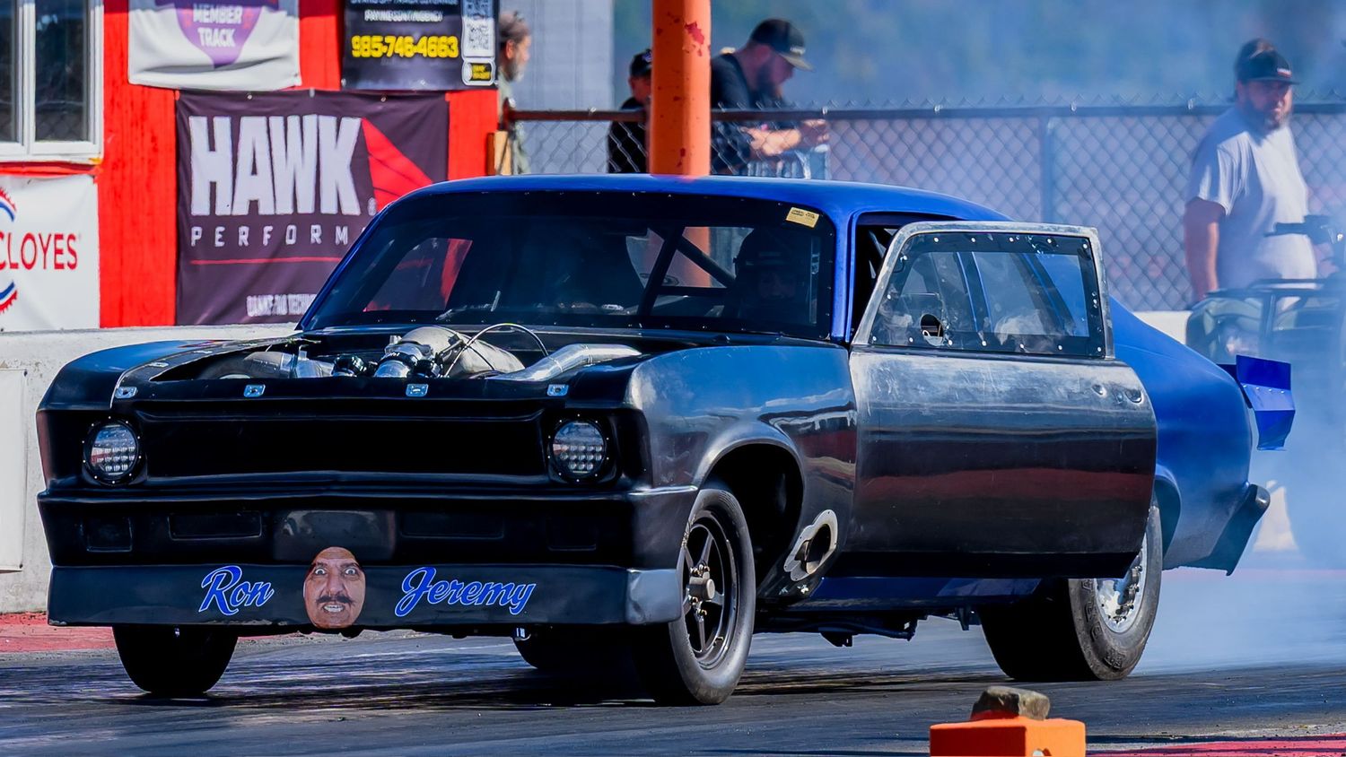 Drag racing competition featuring multiple cars racing down a professional track.