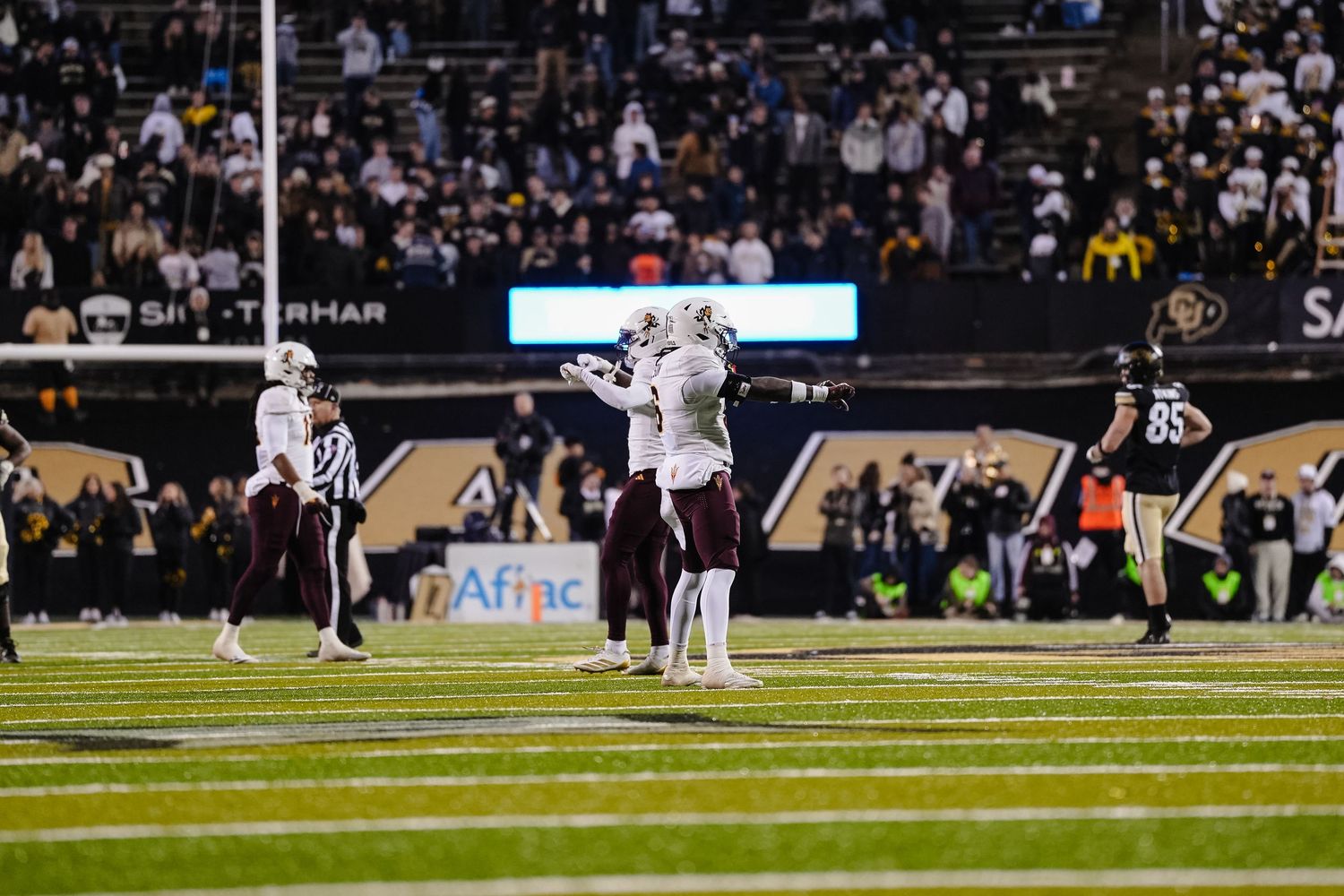 Football players celebrate.