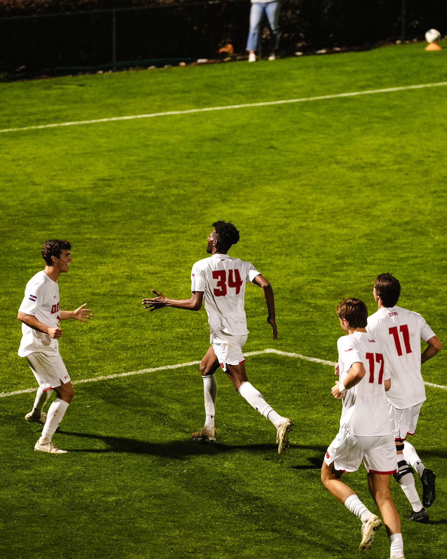 Denver players in white uniforms celebrate.