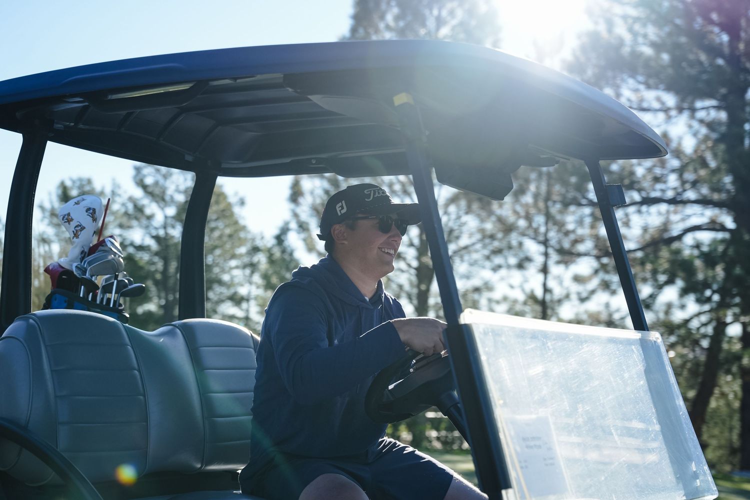 Interior view of golf cart with dashboard and windshield visible.