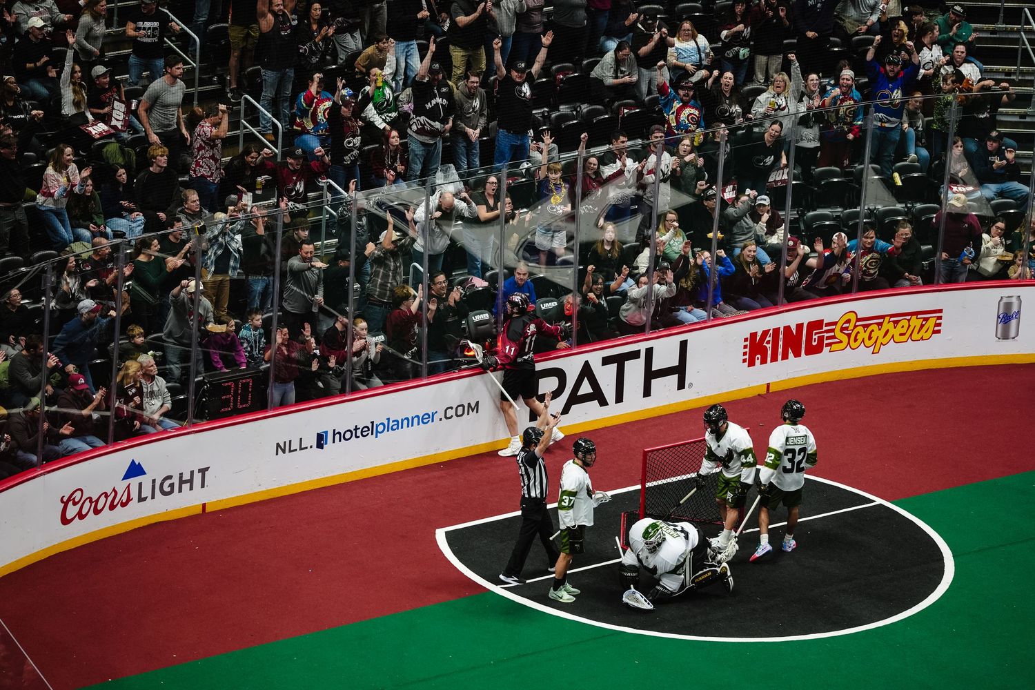 Lacrosse players celebrates a goal.