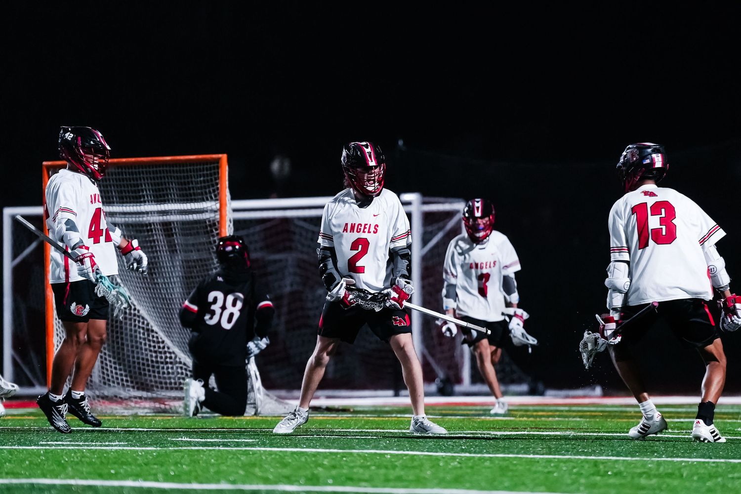 Lacrosse teammates celebrate a goal.