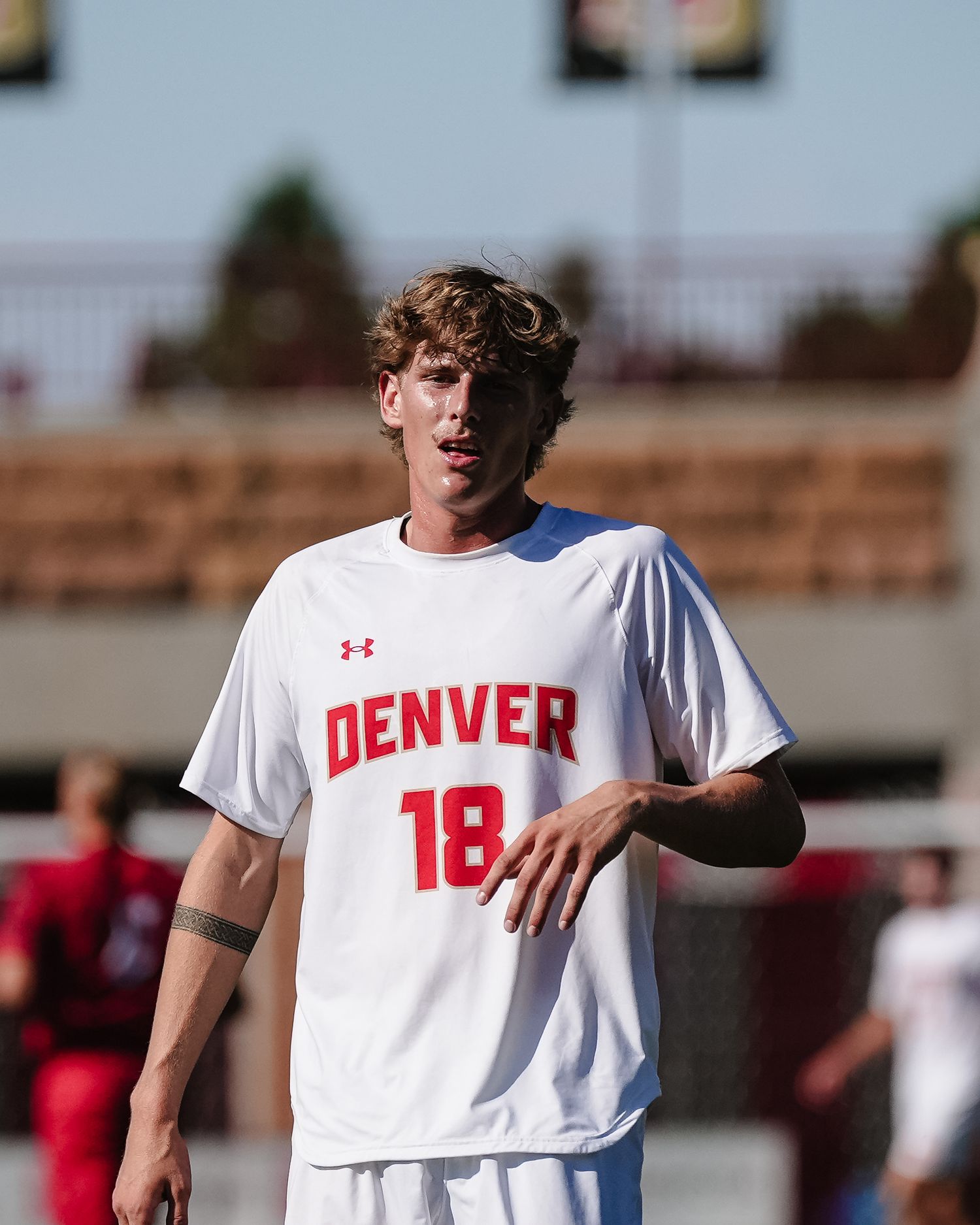 Soccer player in white Denver jersey.