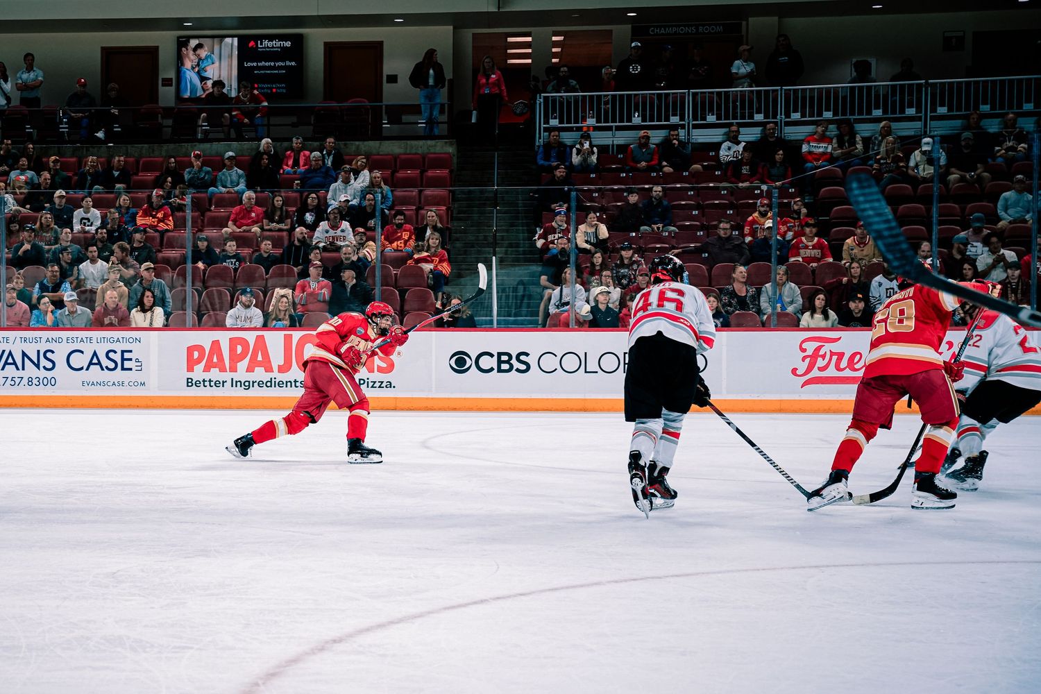 Hockey players compete on the ice during an intense professional match.