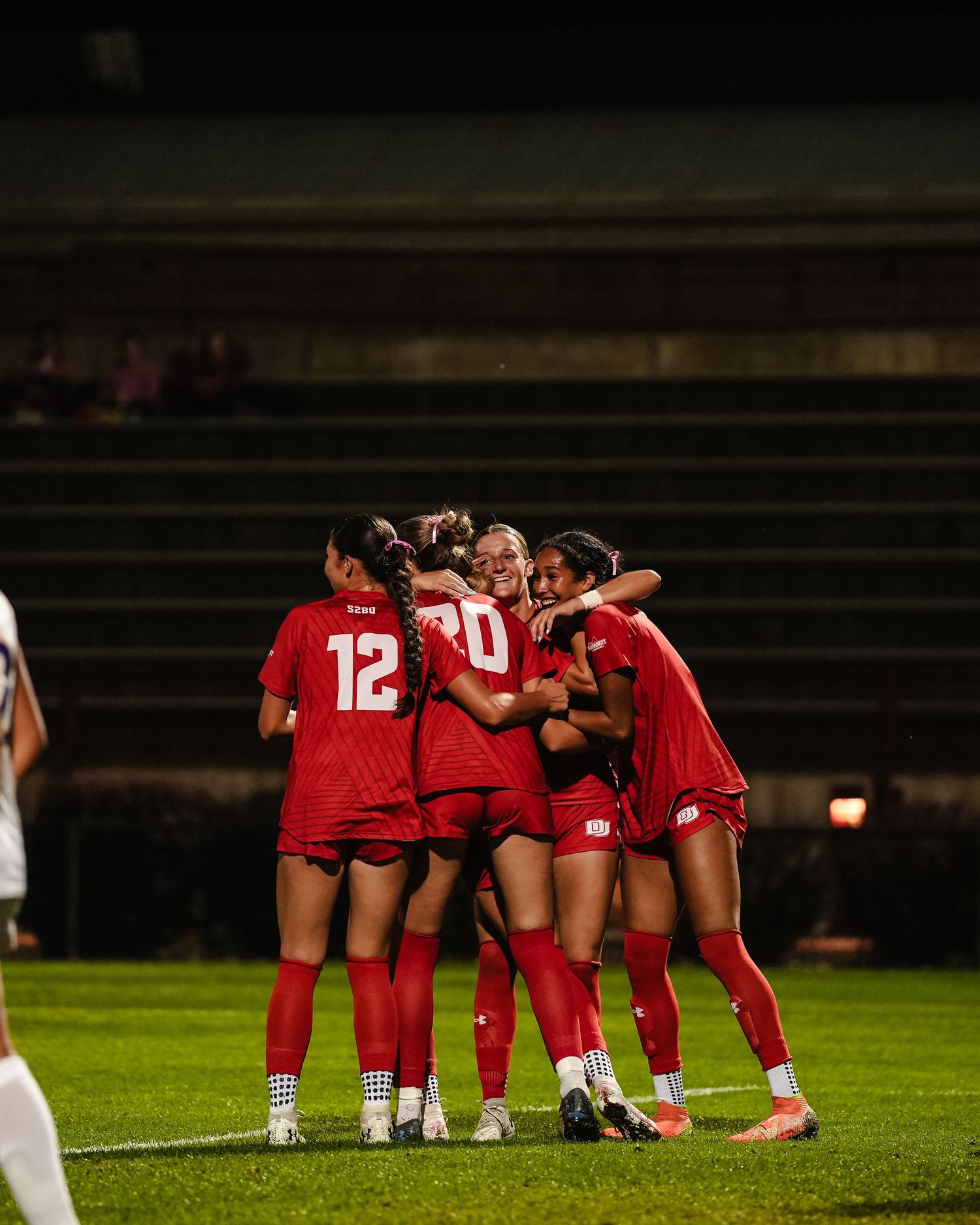 Soccer team celebrating a goal.