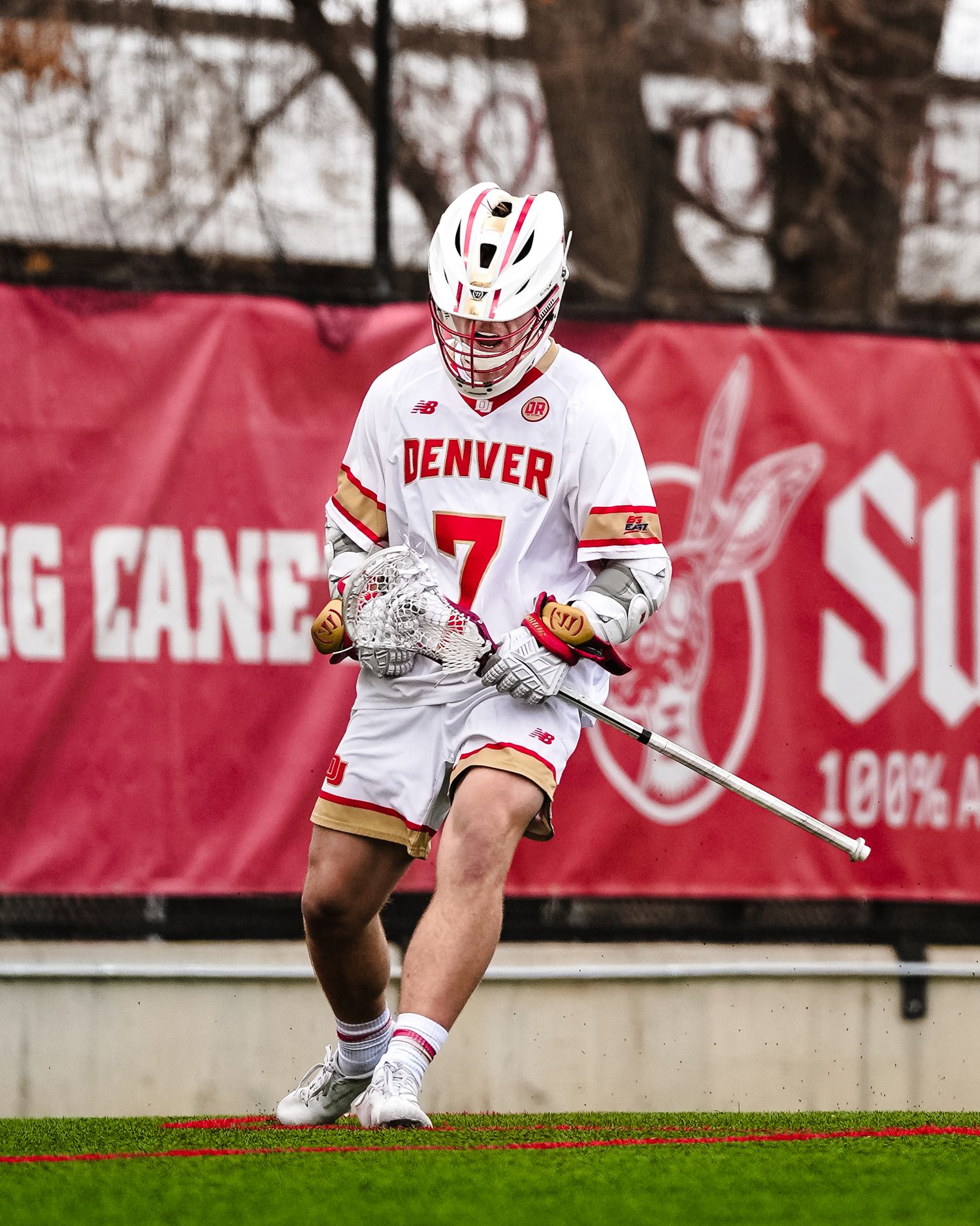 Denver lacrosse player celebrates a goal.
