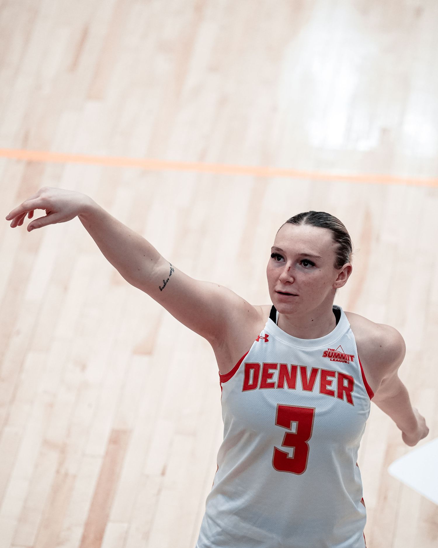 Basketball player in white Denver jersey.