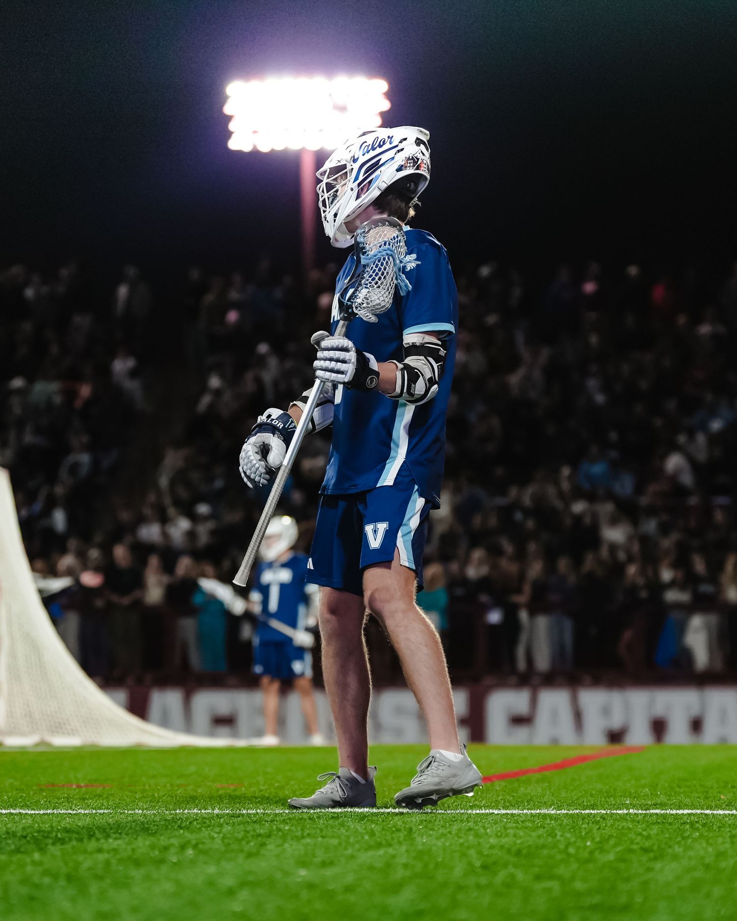 Lacrosse player in blue uniform.