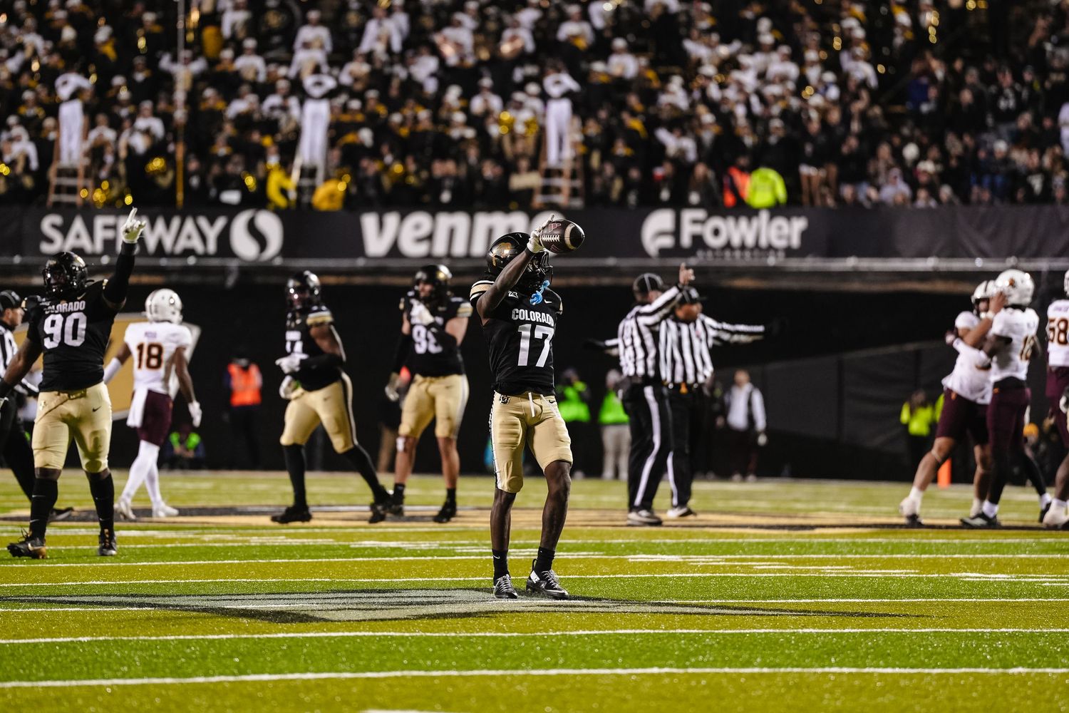 Football field view during night game.