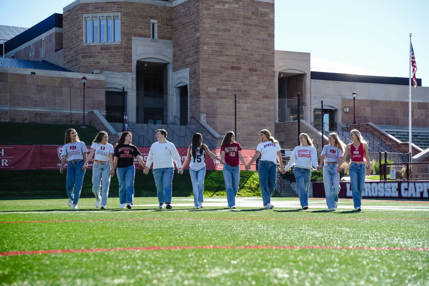 Line of students walking across a sports.