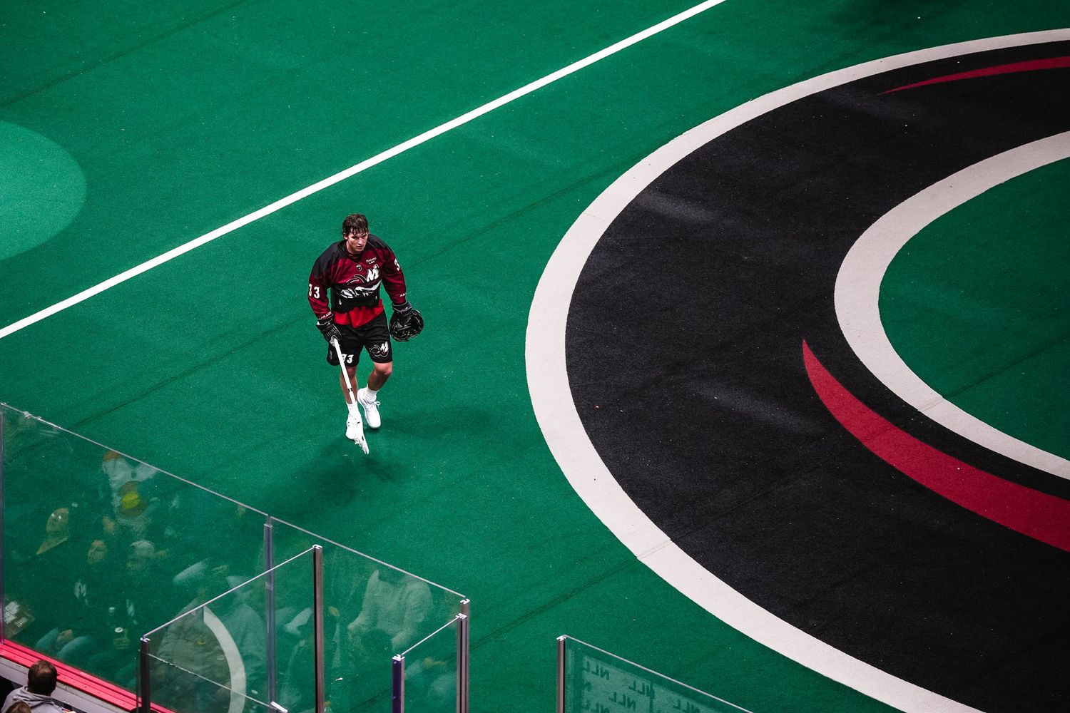 Lacrosse player walks to the box for a penalty.