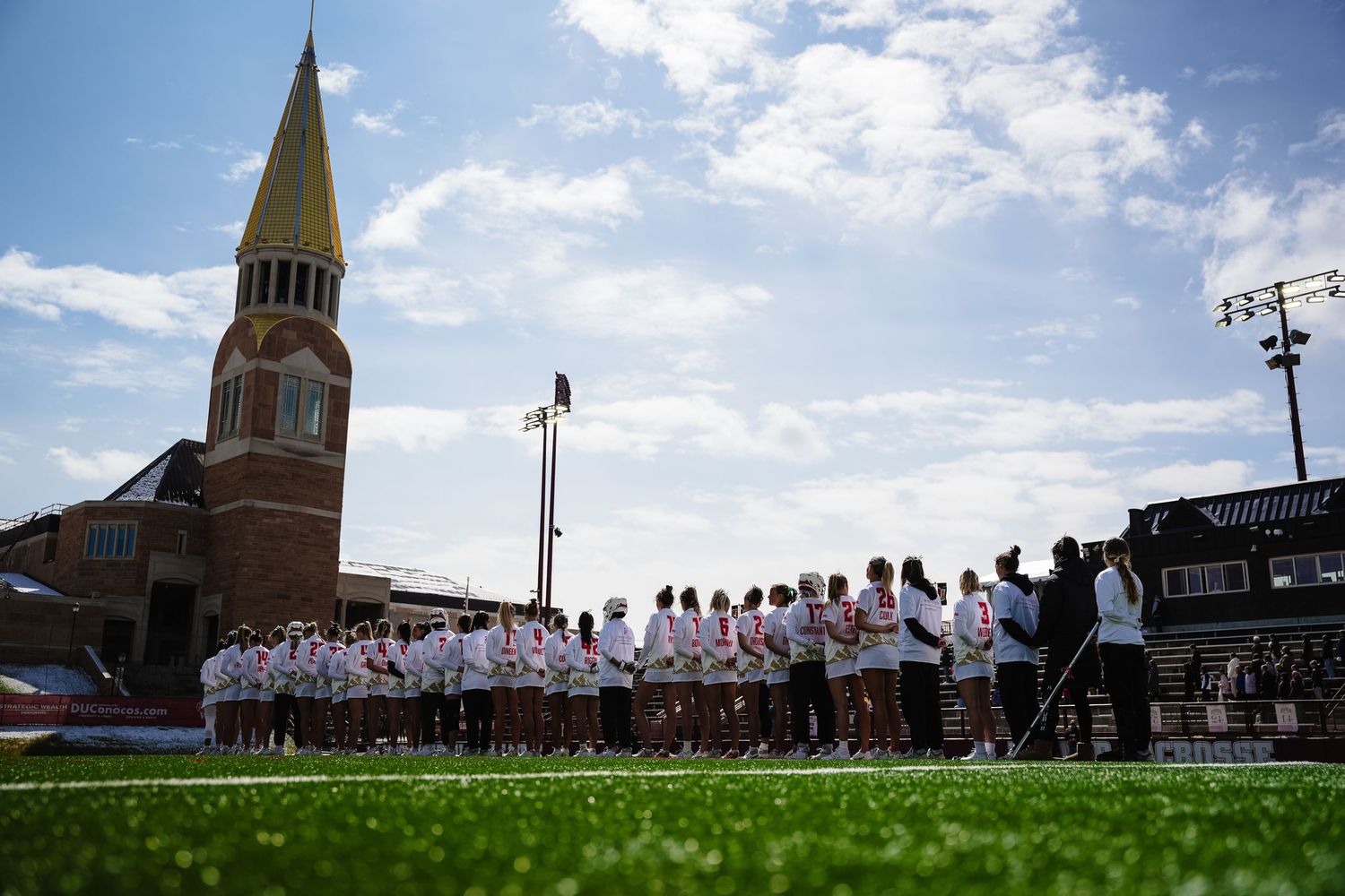 Team members gather on a field.