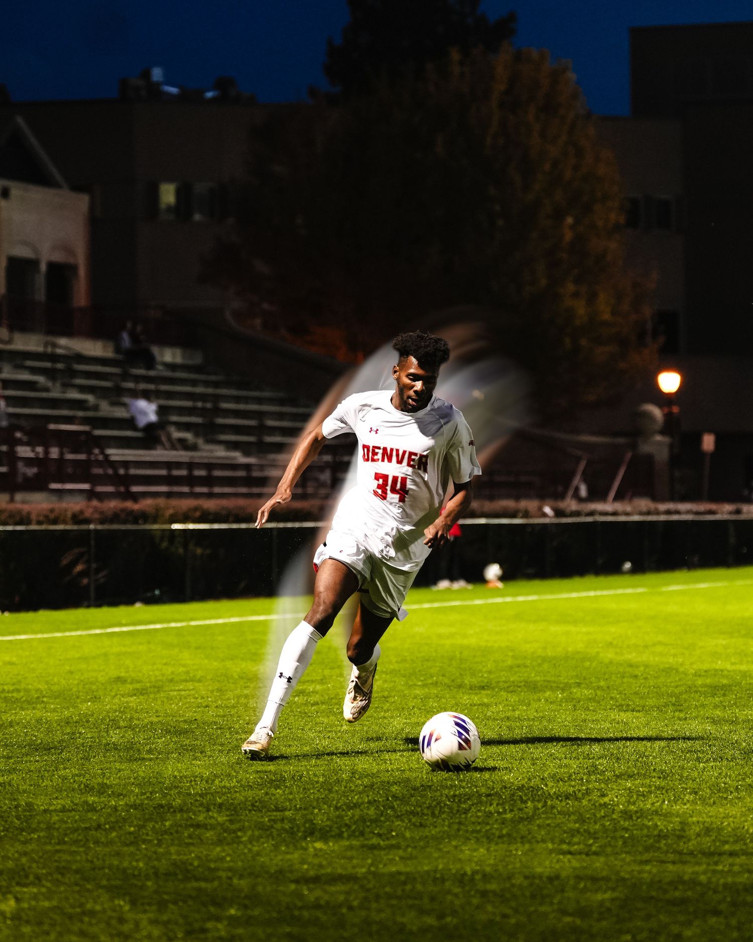 Soccer player dribbling ball.