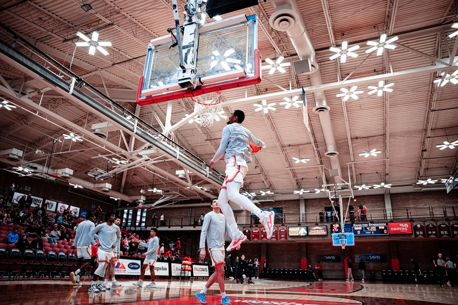 Basketball player dunks.