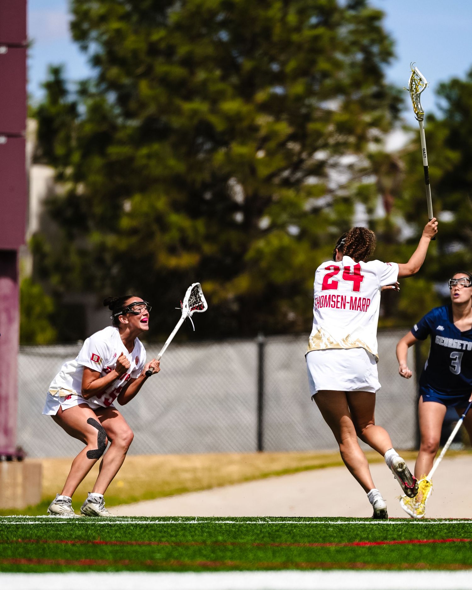 Two lacrosse players celebrating.
