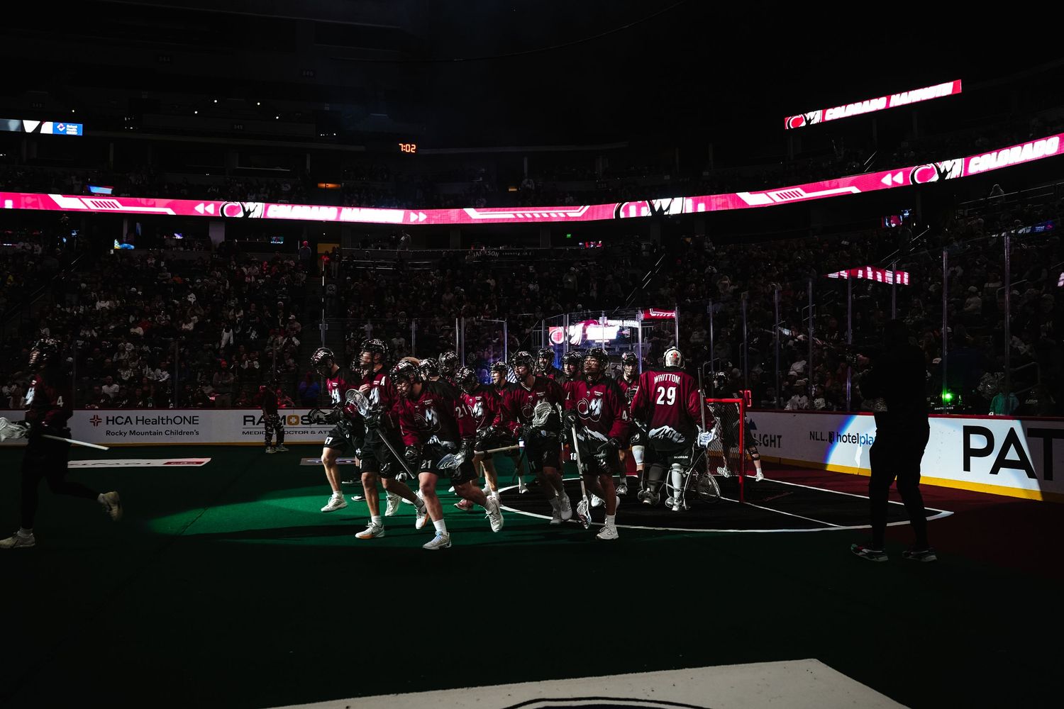 Lacrosse players break from the huddle.
