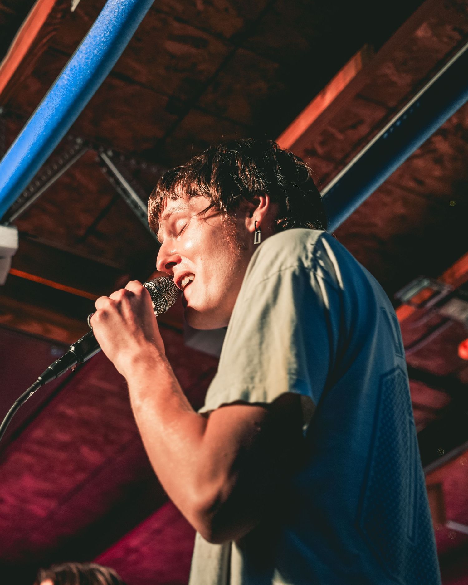 Singer performing passionately on stage.